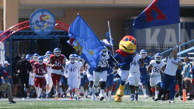 The Kansas football team takes the field during Saturday's spring game at David Booth Kansas Memorial Stadium.